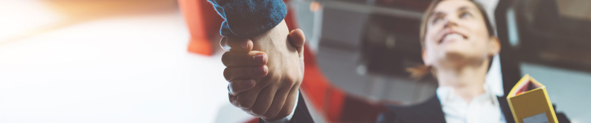 Close-up of a woman&#039;s hand shaking another hand.