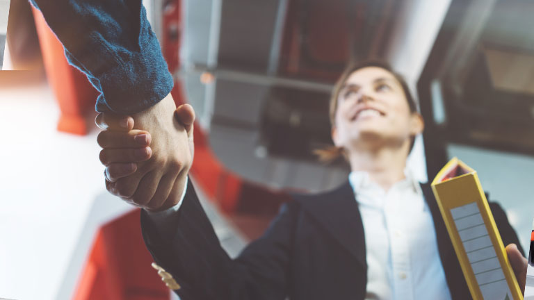 Close-up of a woman's hand shaking another hand.