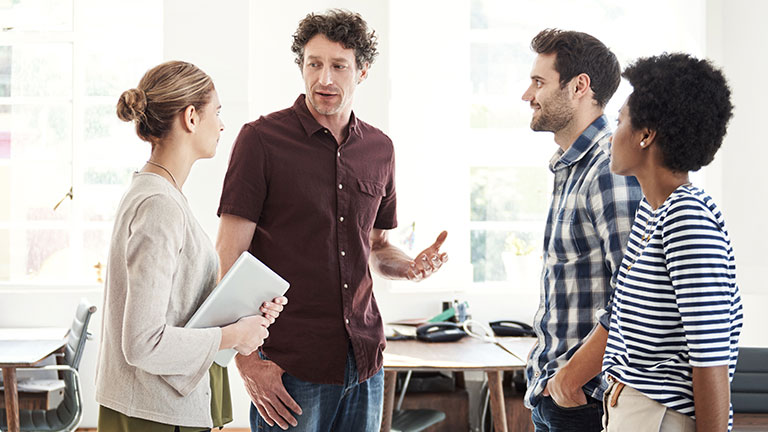 Two women and two men are talking together. 